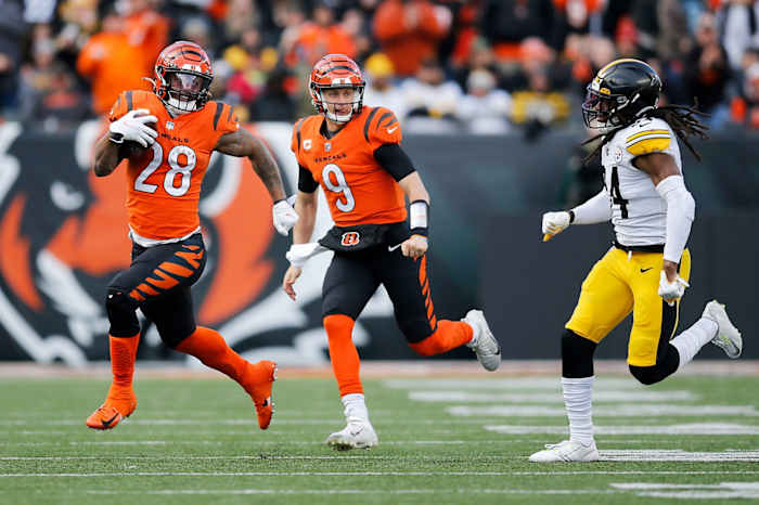 Cincinnati Bengals running back Joe Mixon (28) runs down field on a carry with quarterback Joe Burrow (9) in the third quarter of the NFL Week 12 game between the Cincinnati Bengals and the Pittsburgh Steelers at Paul Brown Stadium in downtown Cincinnati on Sunday, Nov. 28, 2021. The Bengals beat the Steelers 41-10. Pittsburgh Steelers At Cincinnati Bengals